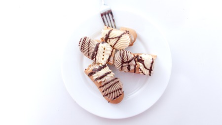picture of a cake pieces of chocolate and vanilla filling.