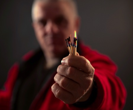 picture of a hand holding Burning Matches. studio shot,close up,の写真素材