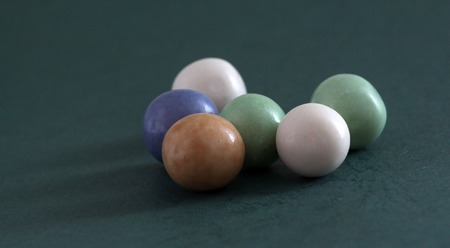 picture of a pile of bubble gum balls on dark green backgroundの写真素材