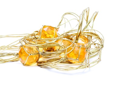 picture of a necklace with cheap plastic gems with golden colored ropeの写真素材