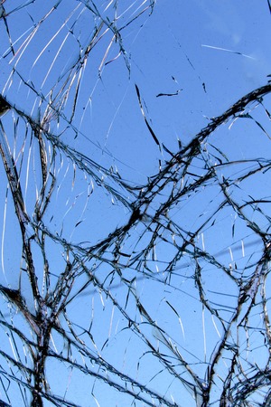 picture of a Close-up broken car windshield. against blue skyの写真素材