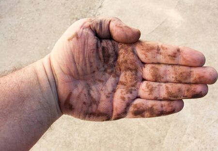 dirty man hands after working on a garden , close up