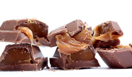 picture of a chopped chocolate piesec with caramel fill , macro, studio shotの写真素材