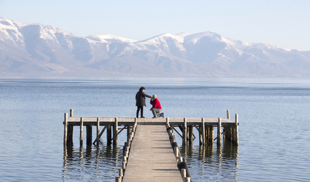 picture of an adult couple romance on a pier of lake prespa,macedoniaの写真素材