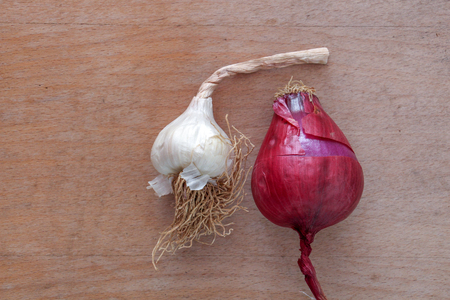 picture of a garlic and spanish onion on wood backgroundの写真素材