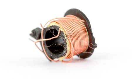 damaged small electric transformer on white, macro shot