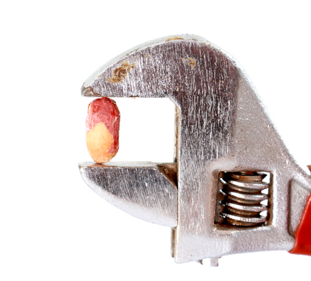 shelled peanut on a pipe wrench,white background