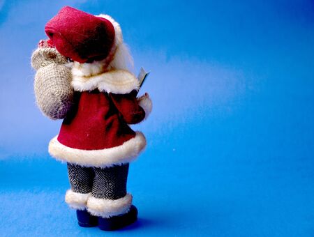 Santa Claus doll on blue background.の写真素材