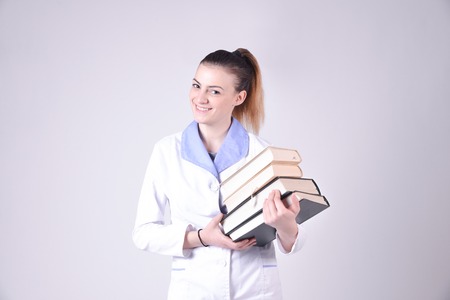 Young nurse portrait with books on a handsの写真素材