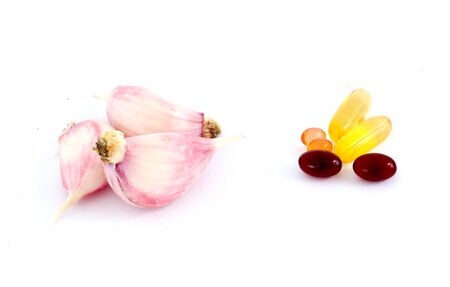 image of a fresh planted young garlic cloves and omega 3 capsulesの写真素材