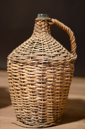 image of a glass bottle for rakia protected by wood meshの写真素材