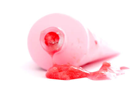 chewing gum with strawberry flavor flows out from tube on whiteの写真素材