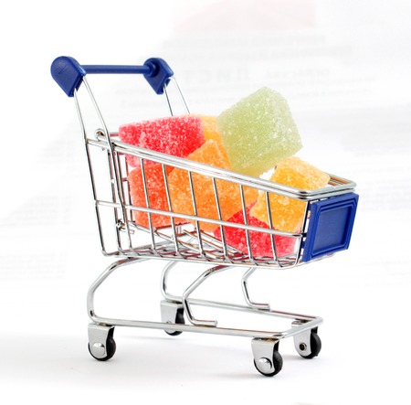 Colored Sweet.Jellies on a shopping cart, white bakground, image ofの写真素材