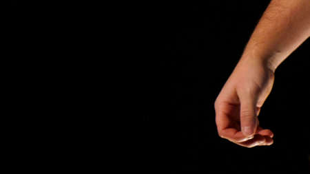man hand on a black background, body part