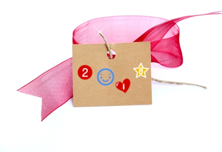 red ribbon and brown carton card with text on white,imageの写真素材