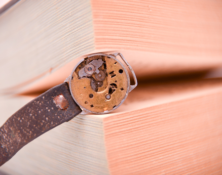 rusty old clock mechanism between book pages, conceptの写真素材