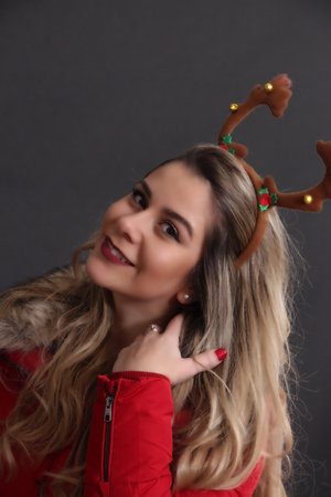 Studio portrait of a girl with Christmas headband in studio,imageの写真素材