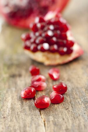 organic pomegranate fruit on a wood background,image of aの写真素材