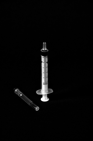 syringe isolated on black,monochrome image of aの写真素材