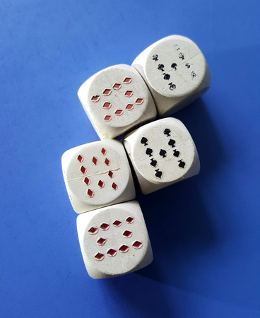 white dices with playing cards symbols on ble background,image