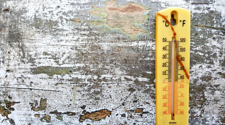 old thermometer on an wood background,image of aの写真素材