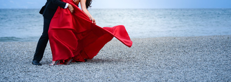 unrecognizable bride and groom dancing on the beach,image of aの写真素材