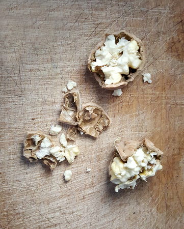 cracked walnut shell on a wooden scratched background,image of a
