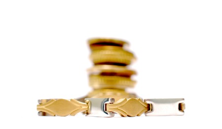 luxury bracelet in front of old coins, shallow dof imageの写真素材