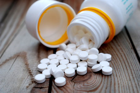 Pill bottle and pills on wood background,の写真素材