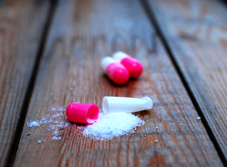 open capsule on wood background,imageの写真素材