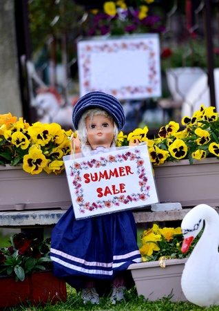 cute doll holding paper with text summer sale, imageの写真素材