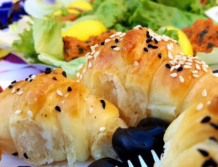 fresh baked rolls with sesame seeds image of aの写真素材