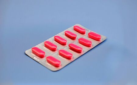 image of a pill son a gray background, healthcare theme