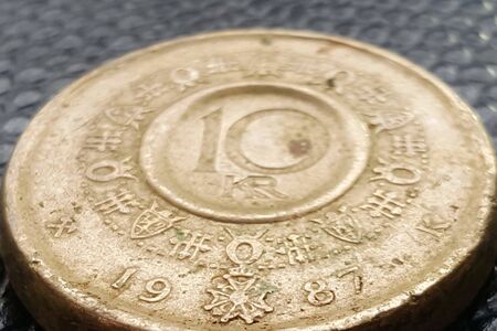 dirty and dusty coin on black background.norway money