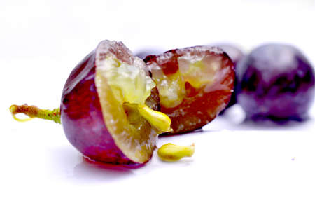 Close-up of red grape on white background imageの写真素材