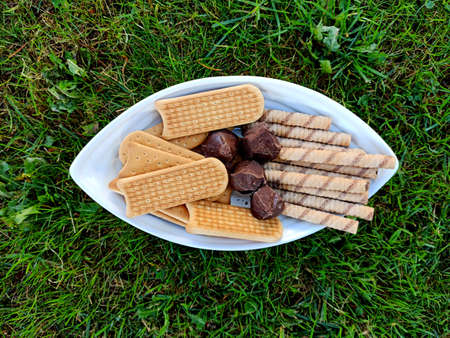 Chocolate bonbons , biscuits anmd rolled hazelnuts sticks.の写真素材
