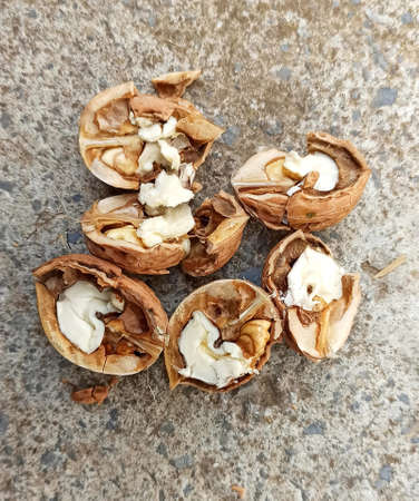 cracked walnuts on a concrete background imageの写真素材
