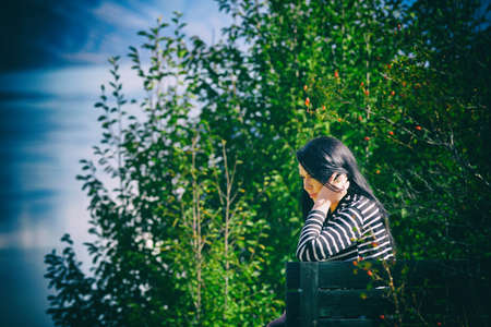 autumn woman portrait in natureの写真素材