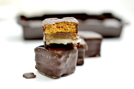 filled chocolate marzipan cubes close up ,sweet food on wood background imageの写真素材