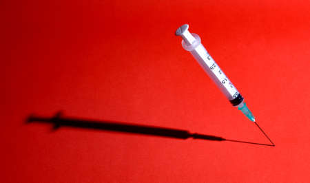 syringe and needle with .shadow.の写真素材