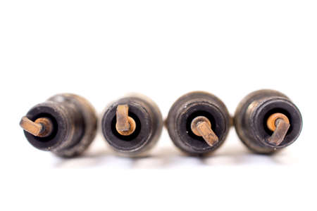 closeup shot of used spark plug on white backgroundの写真素材