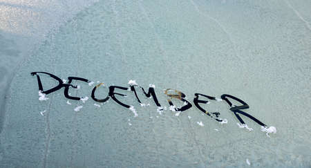 december is written on the windshield of the car, in the snow. New Year. Winter.の写真素材