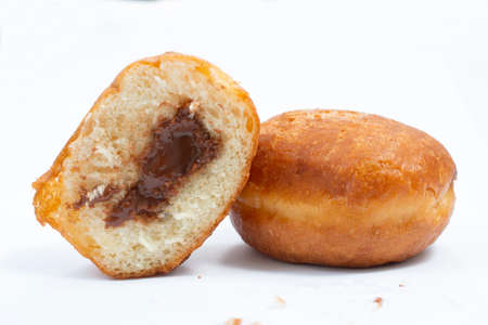small round donuts with chocolate filling on white backgroundの写真素材