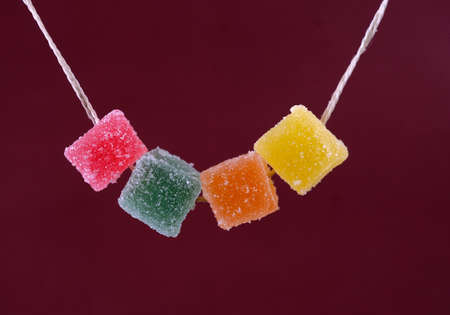 jelly candies colorful in sugar hanging on a rope