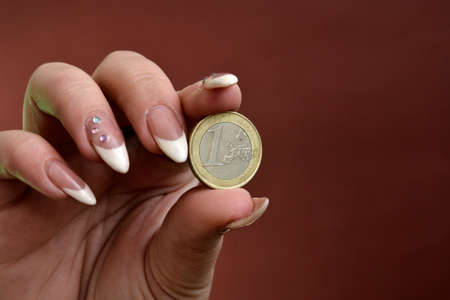 woman hand hodling euro coin