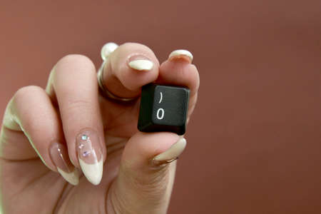 woman hand hodling Black computer keyboard key close upの写真素材