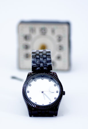 Luxury men watchin front ov vintage alarm clock . Time concept
