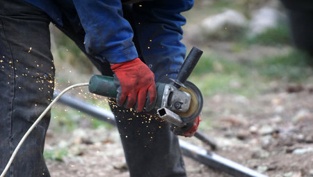 Metal processing with grinder. cutting metal on location of conctruction site, Sparks in metalworkingの写真素材