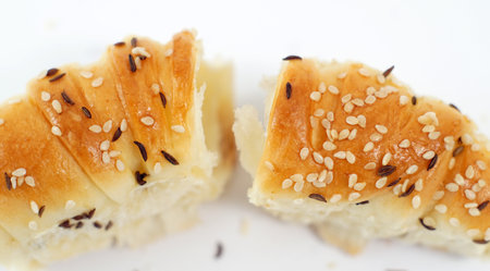 Homemade traditional fresh baked rolls with black caraway and sesame seeds.