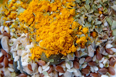 Dry turmeric powder, curcuma longa linn, on various seeds. Top view.の写真素材
